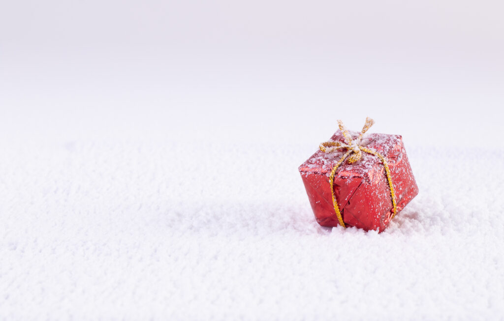 Minimalist Winter Wallpaper: Red Gift Box on Pristine Snow