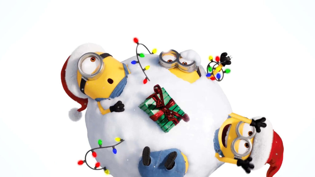 Cheerful Minions Celebrate Christmas on Snowball Wallpaper