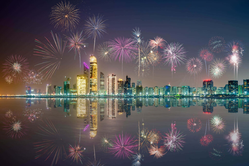 Vibrant New Year's Eve Fireworks Over Water - Festive Wallpaper