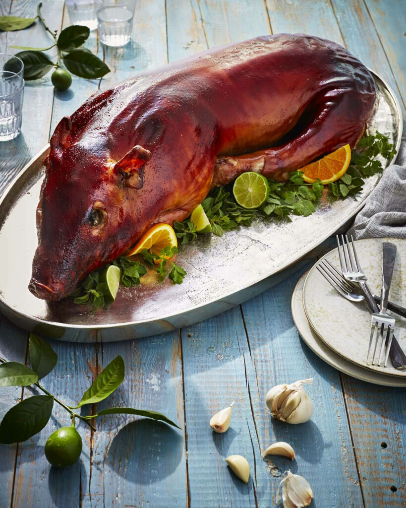 Festive Roast Piglet Lechon on Metallic Platter - Wallpaper Background