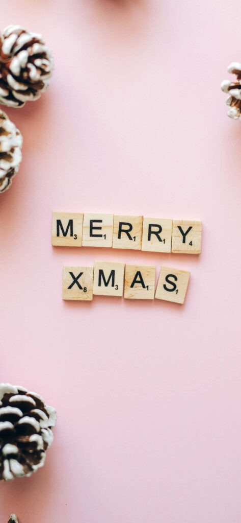 Festive Merry Xmas Wallpaper with Scrabble Tiles on Pink Background