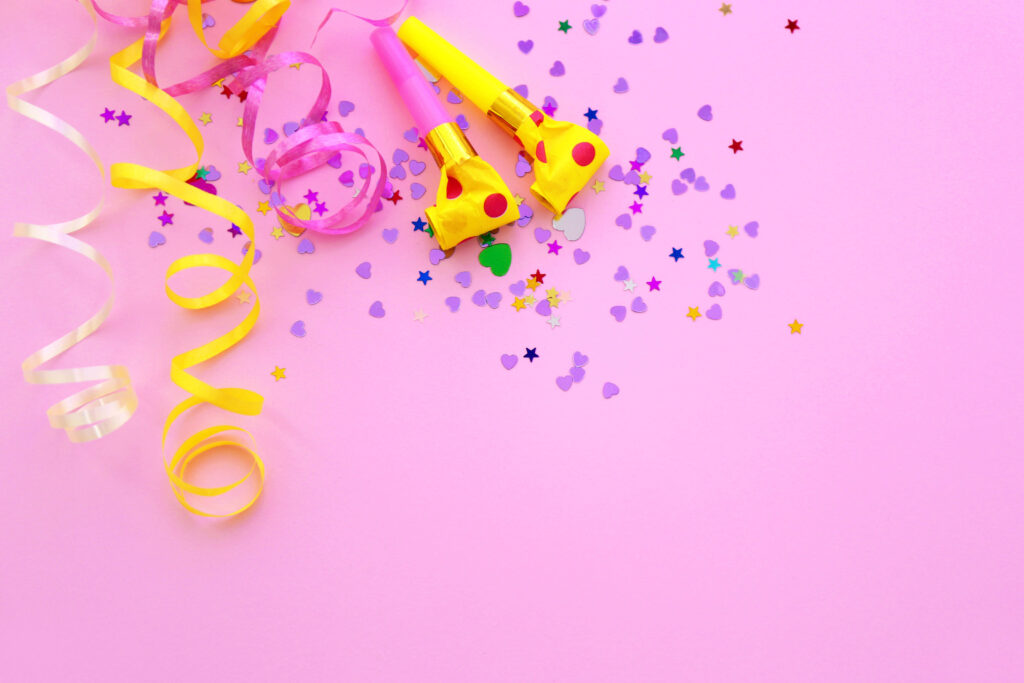 Festive Pink Wallpaper with Colorful Party Blowgers and Confetti