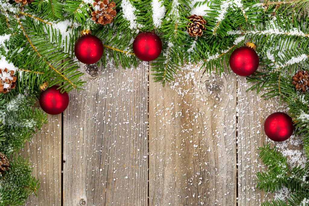 Rustic Wooden Background with Festive Snow-Dusted Christmas Garland Wallpaper
