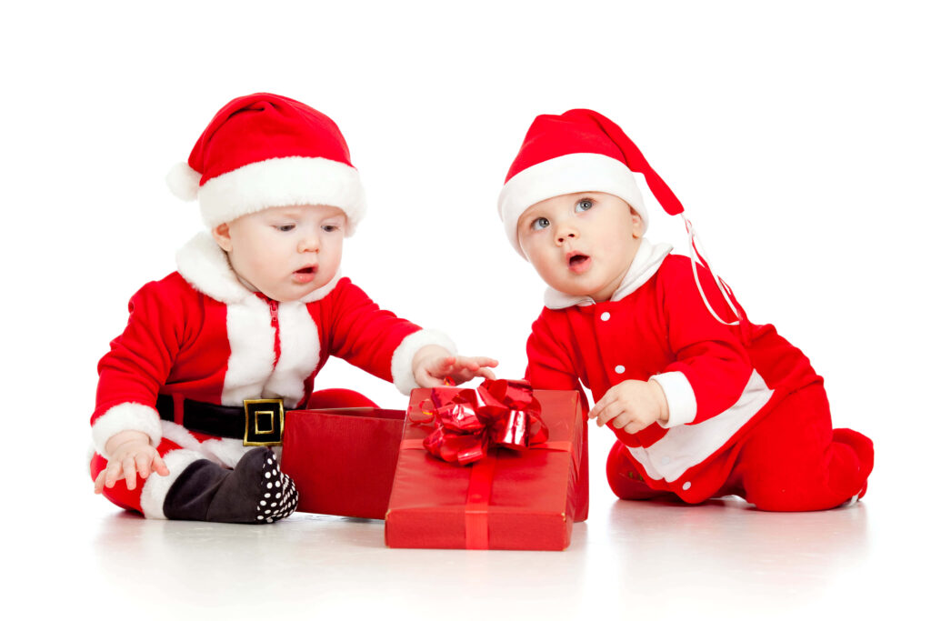 Festive Santa Babies Exploring a Gift Box - Heartwarming Xmas Wallpaper
