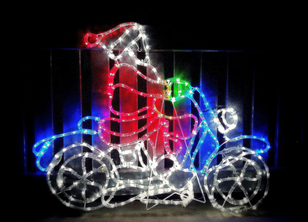 Festive Santa on Motorcycle: Sparkling Lights Create Magical Holiday Scene Wallpaper