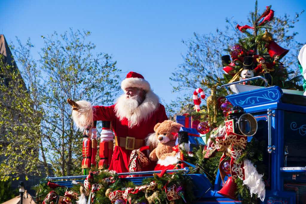 Festive Santa Claus Parade Float Wallpaper with Cheerful Decorations