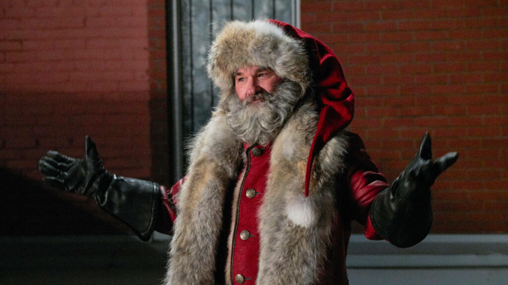 Festive Santa Claus Wallpaper: Holiday Cheer Against Brick Background
