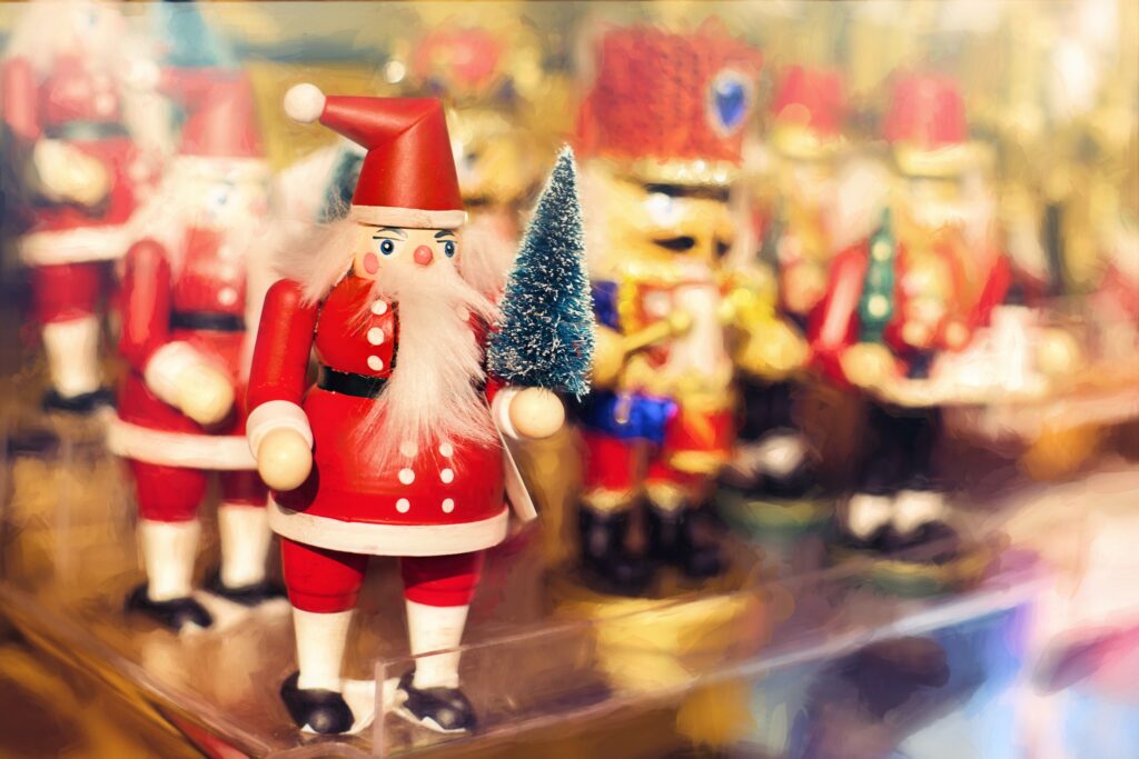Charming Santa Claus Figurine with Nutcracker Background Wallpaper