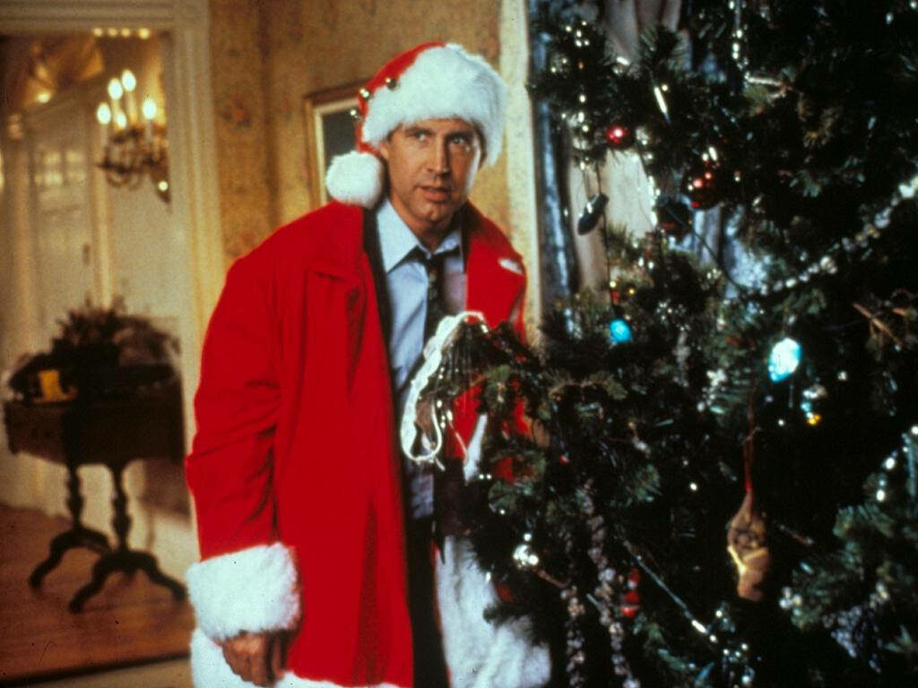 Festive Santa by Christmas Tree - Holiday Spirit Wallpaper