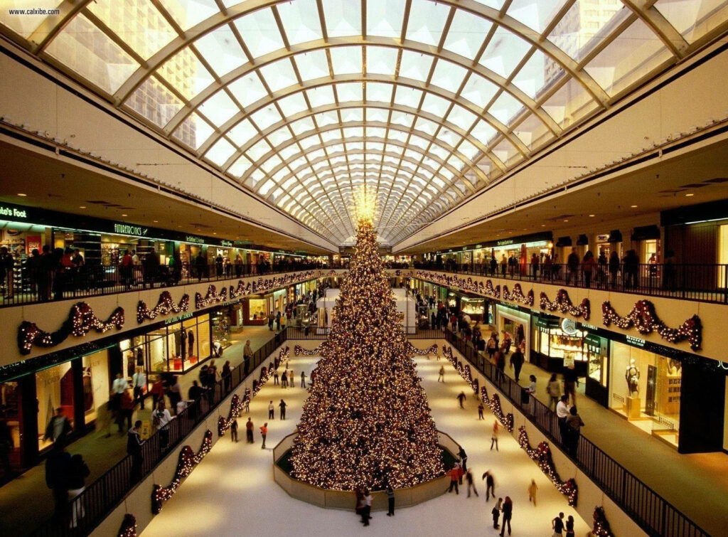 Festive Shopping Mall Wallpaper with Giant Christmas Tree