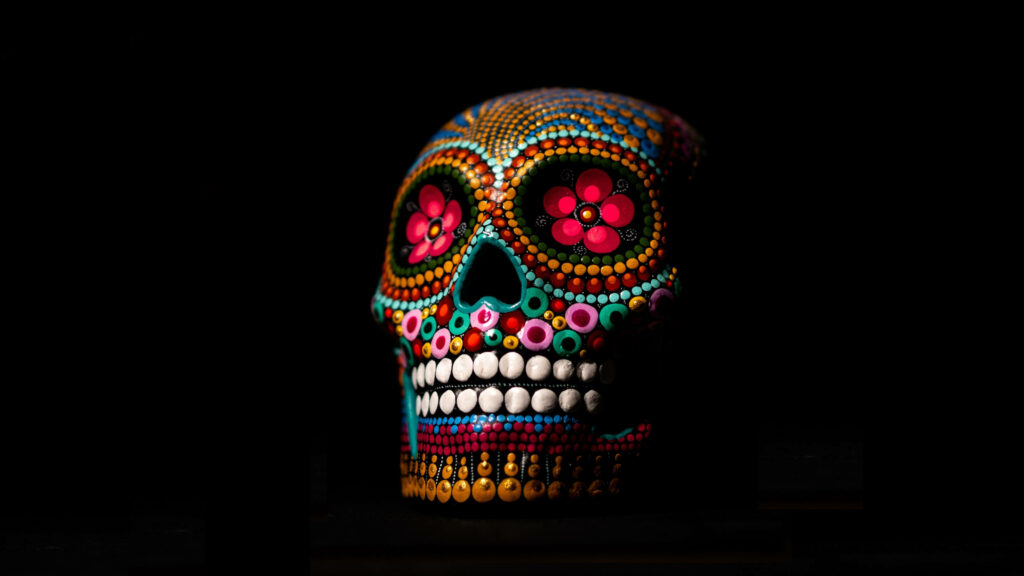 Festive and Colorful Human Skull: A Mesmerizing Digital Art for Vibrant Monitor Backgrounds Wallpaper