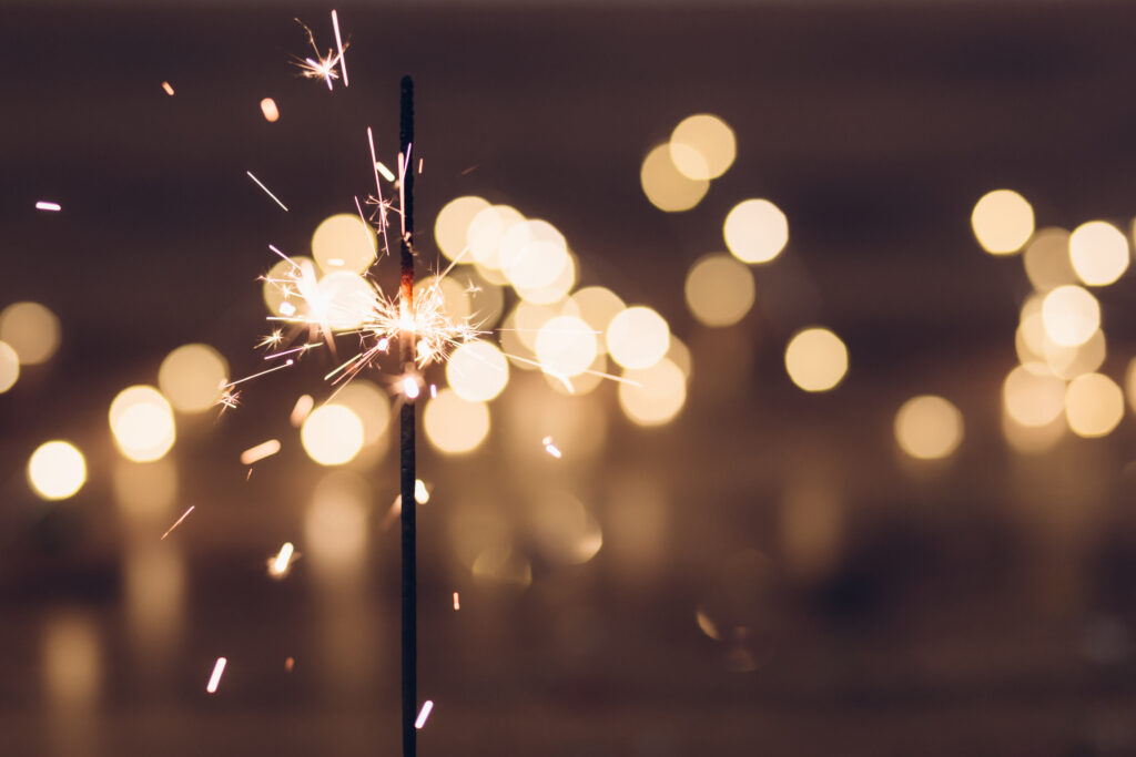 Festive Sparkler Wallpaper: Bright Sparks & Golden Bokeh Background