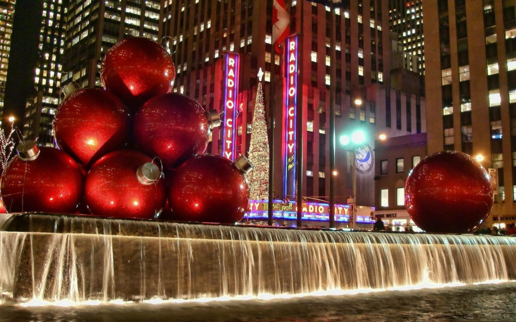 Festive Splendor: Enchanting Red Ornaments Adorning the Iconic Rockefeller Center at Christmastime Wallpaper