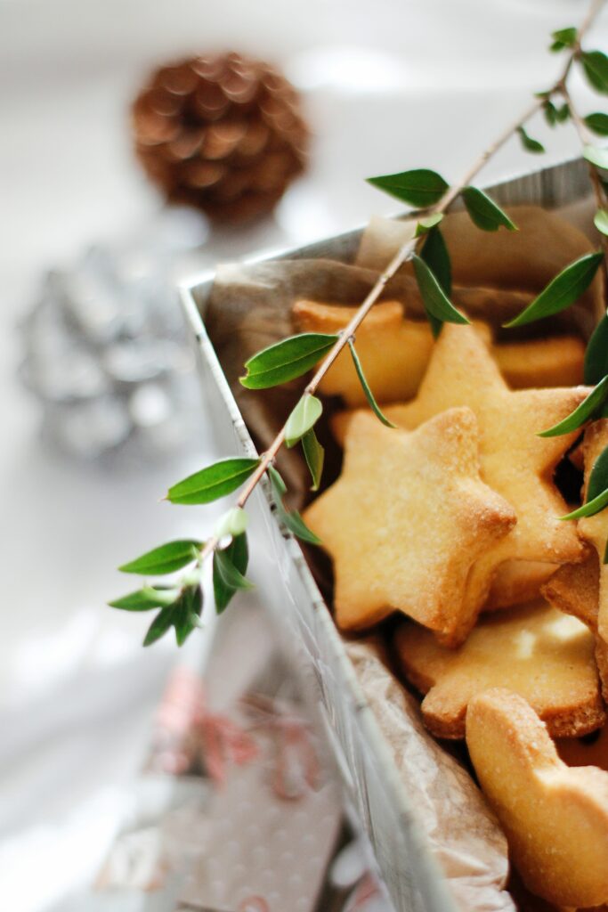 Festive Star-Shaped Cookies Wallpaper with Green Branch Decor