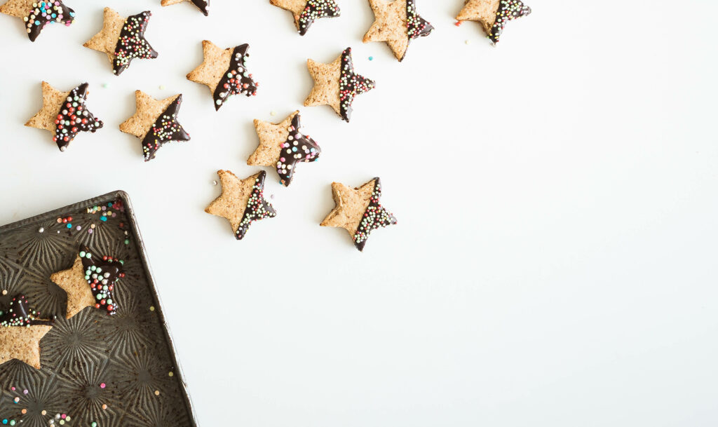 Festive Star-Shaped Cookies with Sprinkles on Bright Background Wallpaper