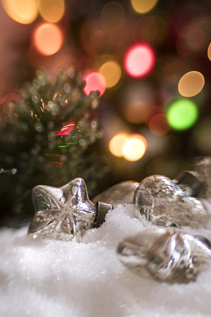 Festive Snowy Scene with Toy Decorations & Warm Bokeh Background Wallpaper