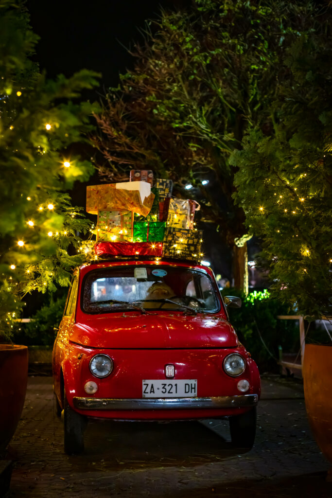 Festive Red Fiat 500 Wallpaper with Colorful Gift Boxes & Lights