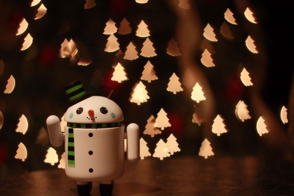 Festive Snowman Wallpaper with Christmas Tree Bokeh Lights