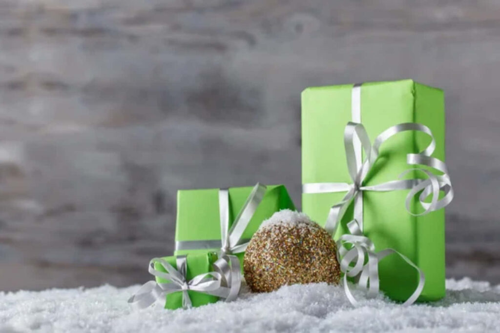 Elegant Green Christmas Gifts on Snowy Background Wallpaper