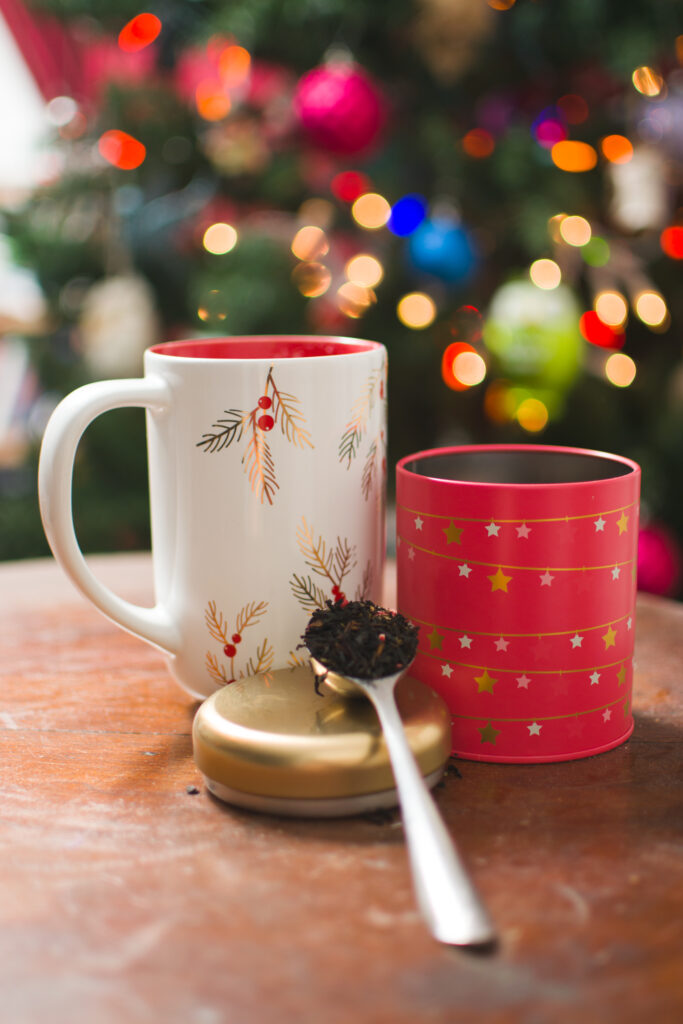 Festive Wallpaper: Holiday Mug & Tea Leaves with Christmas Tree Blur