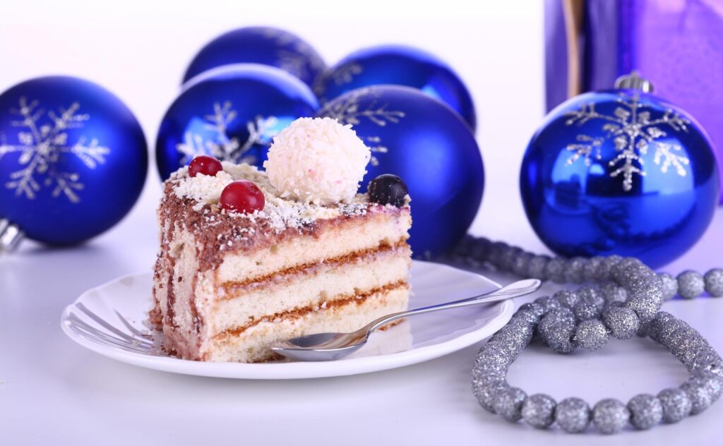 Festive Layered Cake Wallpaper with Christmas Ornaments Background