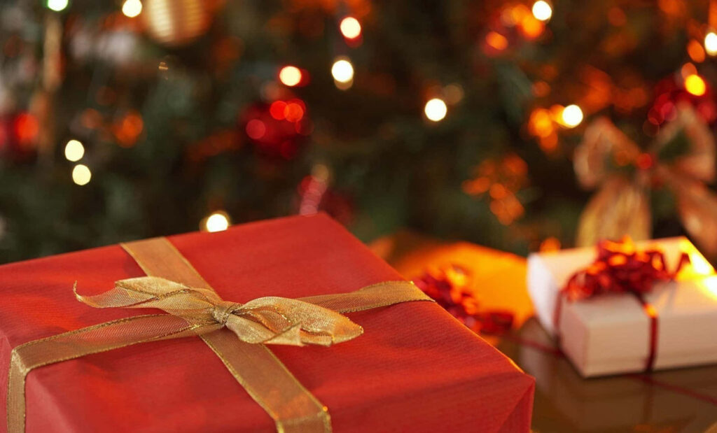 Elegant Red Gift with Gold Ribbon | Festive Christmas Wallpaper