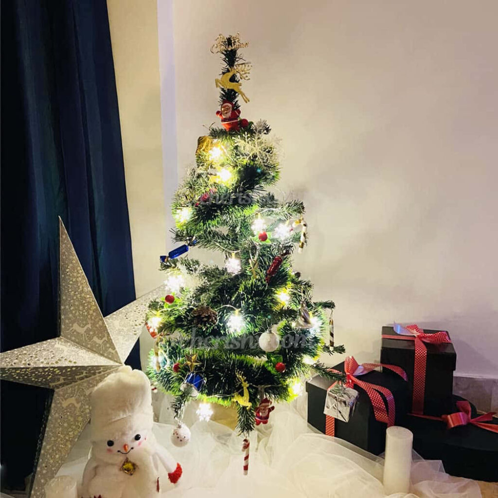 Festive Christmas Tree with Warm Lights, Ornaments & Holiday Decor Wallpaper