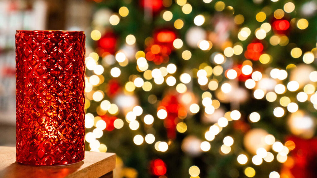 Festive Background: Textured Red Candle & Christmas Tree Glow Wallpaper