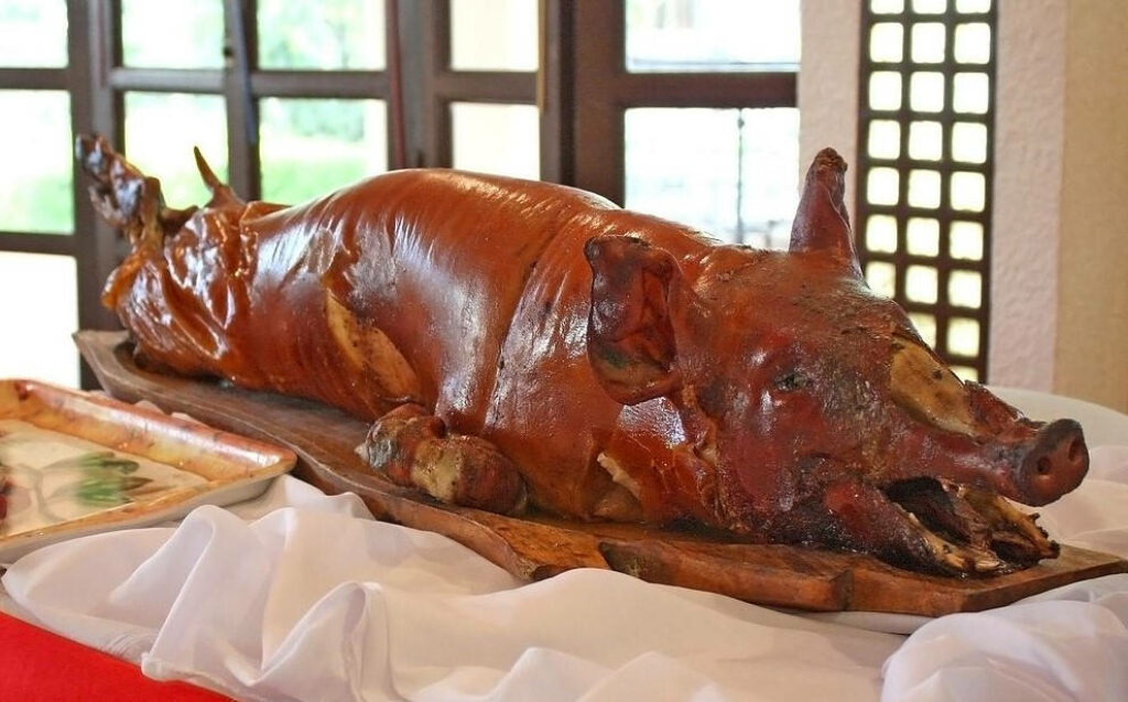 Festive Whole Lechon Feast: Crispy Golden-Brown Delight Wallpaper