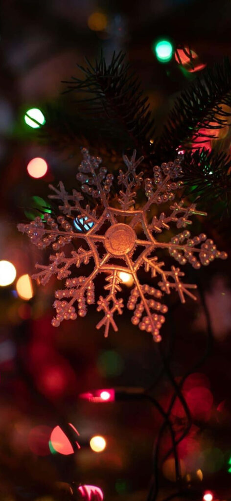 Festive iPhone Wallpaper: Snowflake Ornament & Colorful Christmas Lights