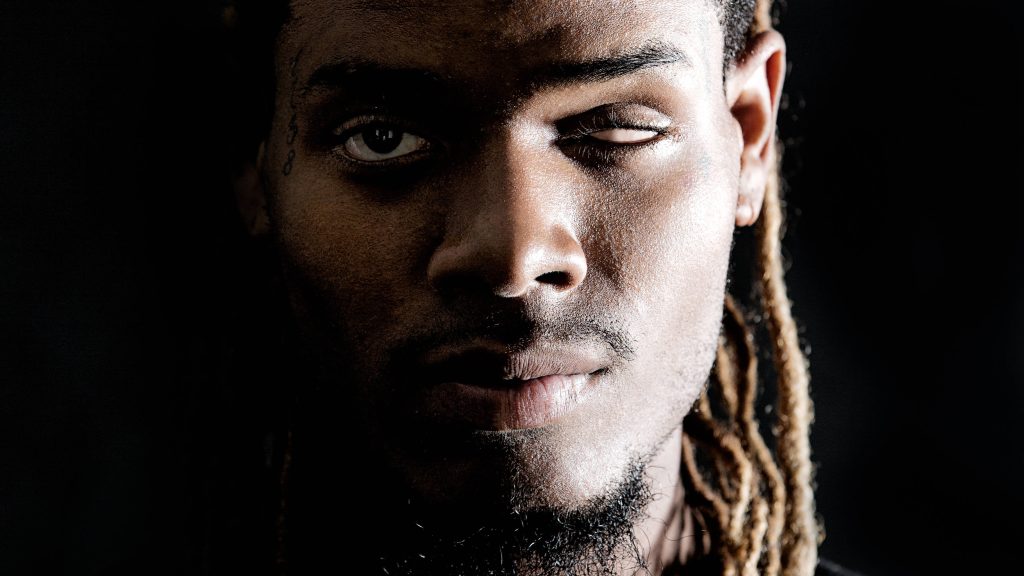 Close-up portrait of award-winning musician Fetty Wap in dramatic shadows with dreadlocks Wallpaper