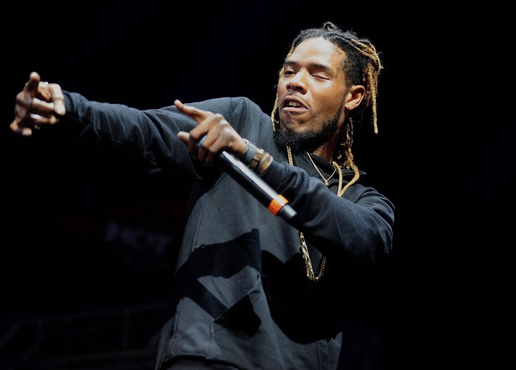 Fetty Wap performing live in black hoodie with dreadlocks under dramatic stage lights wallpaper