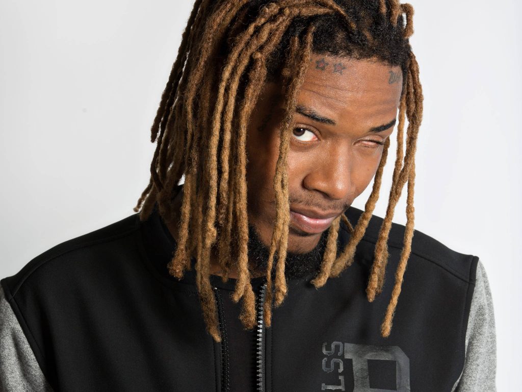 Portrait of rapper Fetty Wap with light brown dreadlocks wink tattooed star forehead black jacket Wallpaper