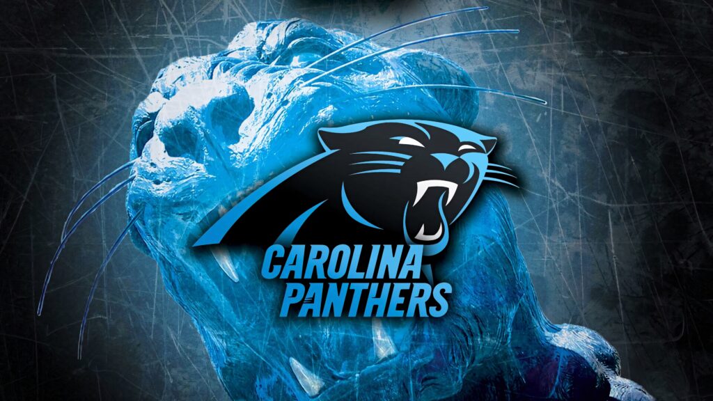 Fierce roaring blue Carolina Panthers with bold logo and black blue tones sports wallpaper background