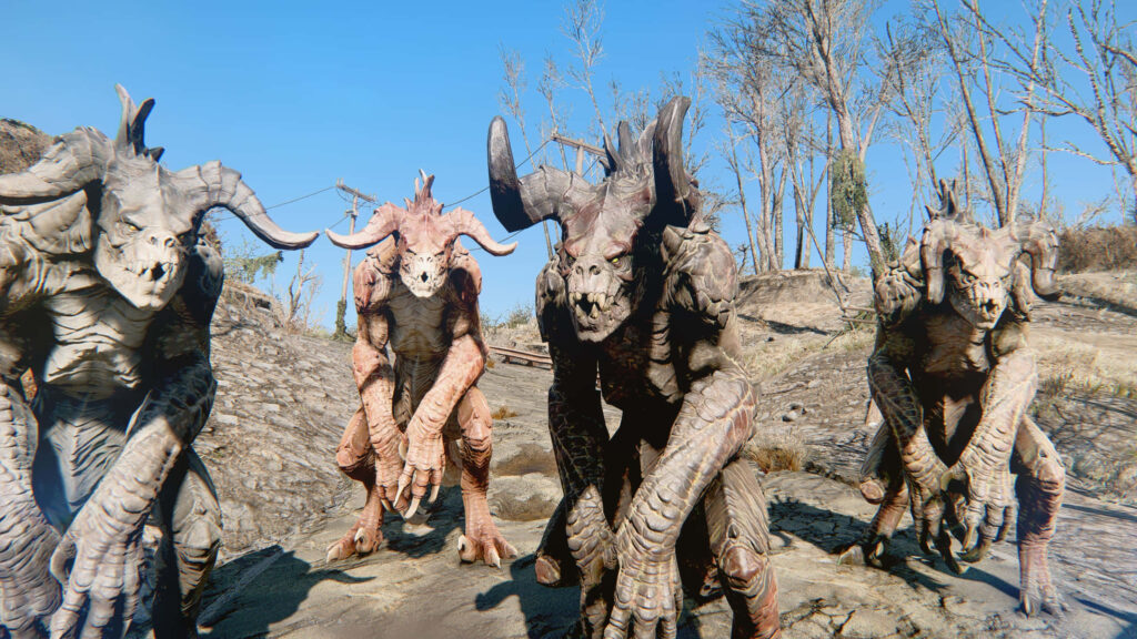 Fierce Deathclaws in Fallout wasteland with detailed horns and claws under clear blue sky wallpaper