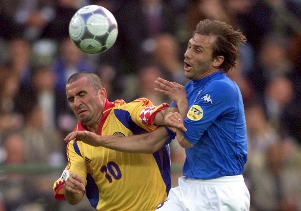 Football legends Gheorghe Hagi and Antonio Conte in intense aerial duel action sports wallpaper