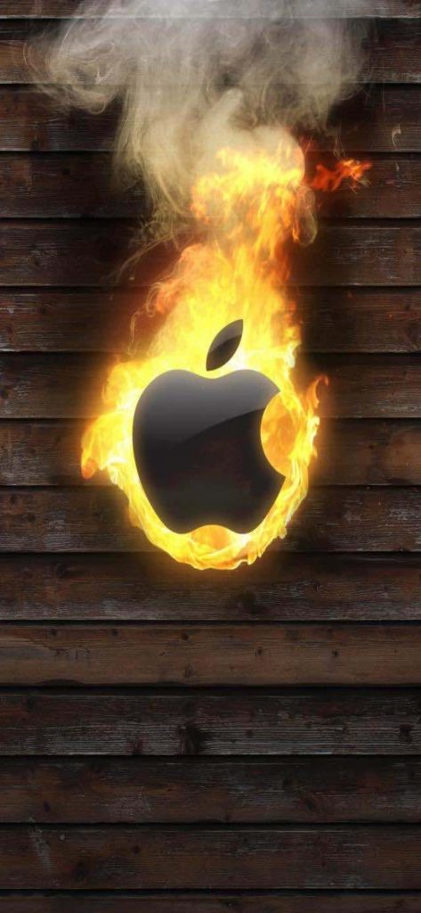 Black Apple logo engulfed in vibrant flames on rustic dark wood iPhone wallpaper background