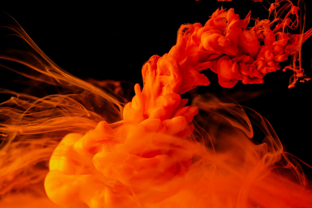 Red and Orange Ink Burst: A Vivid Abstract Expression on Ebony Canvas Wallpaper