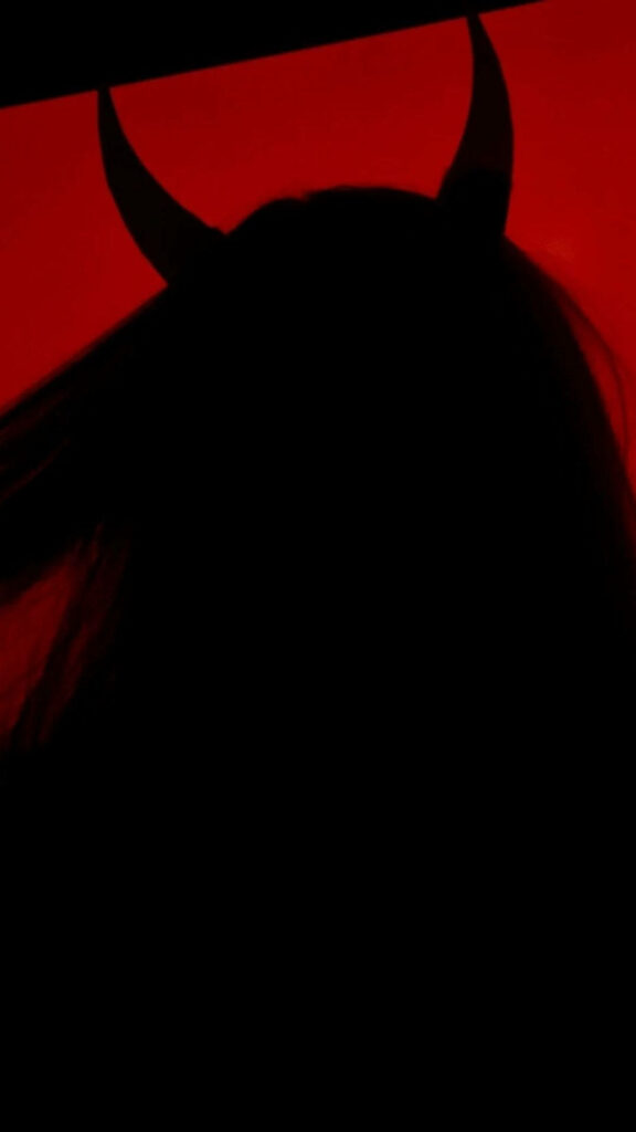 Seductive Shadows: Captivating Horned Temptress in Fiery Background Wallpaper