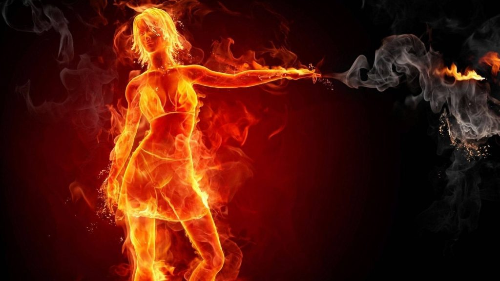 Powerful female figure in fiery swimsuit unleashing flames and smoke on black background wallpaper