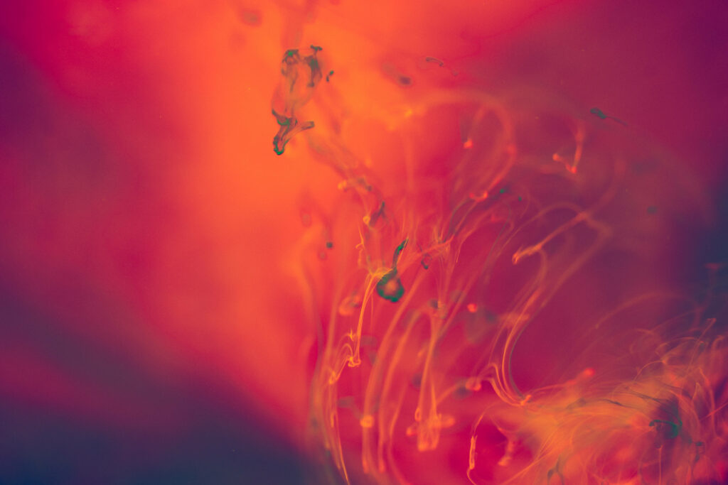 Fiery Dance: Vibrant Hues Twirling in an Enigmatic Glow - Dynamic HD Abstract Wallpaper