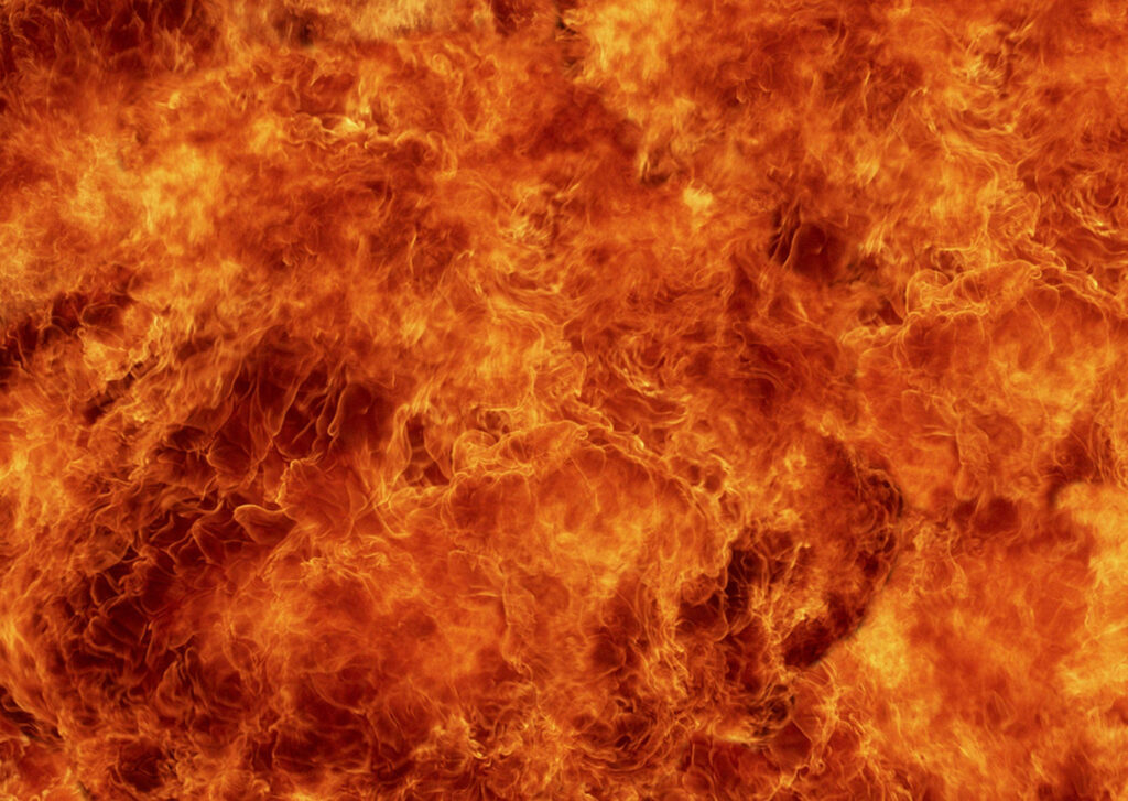 Blazing fire wallpaper with vibrant orange yellow and red swirling flames high resolution background