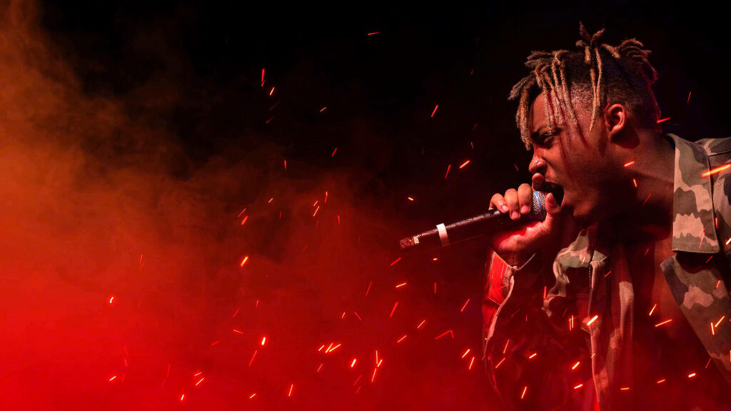 Fiery Serenade: Juice Wrld's Epic Performance Ignites in the Background Wallpaper