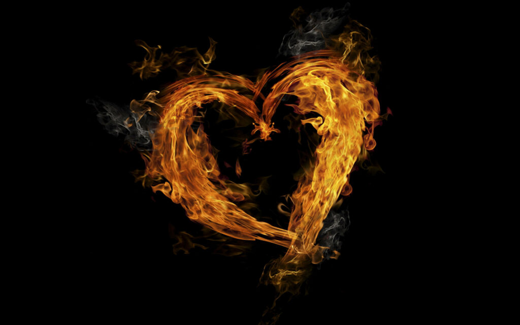 Flaming heart wallpaper with vibrant fiery orange and yellow flames on black background