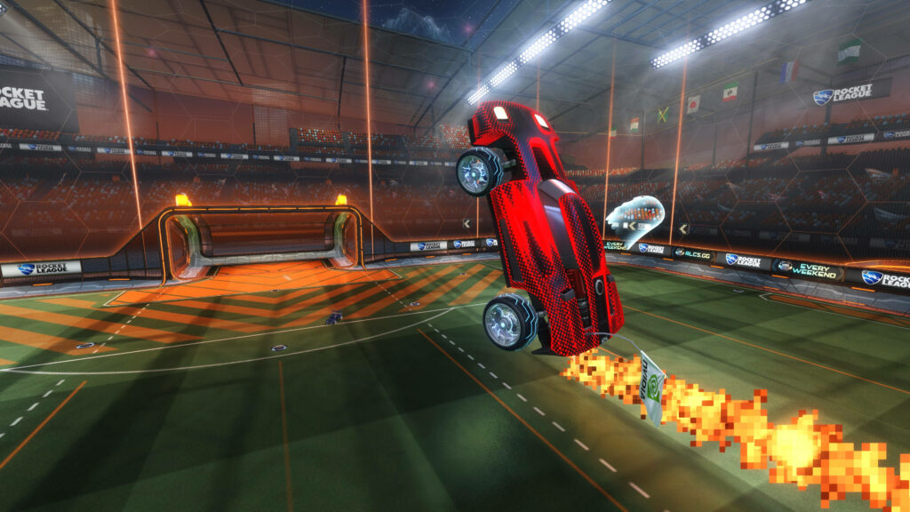 Explosive Action: Rocket League's Fiery Red Car Rockets Across the Field Wallpaper