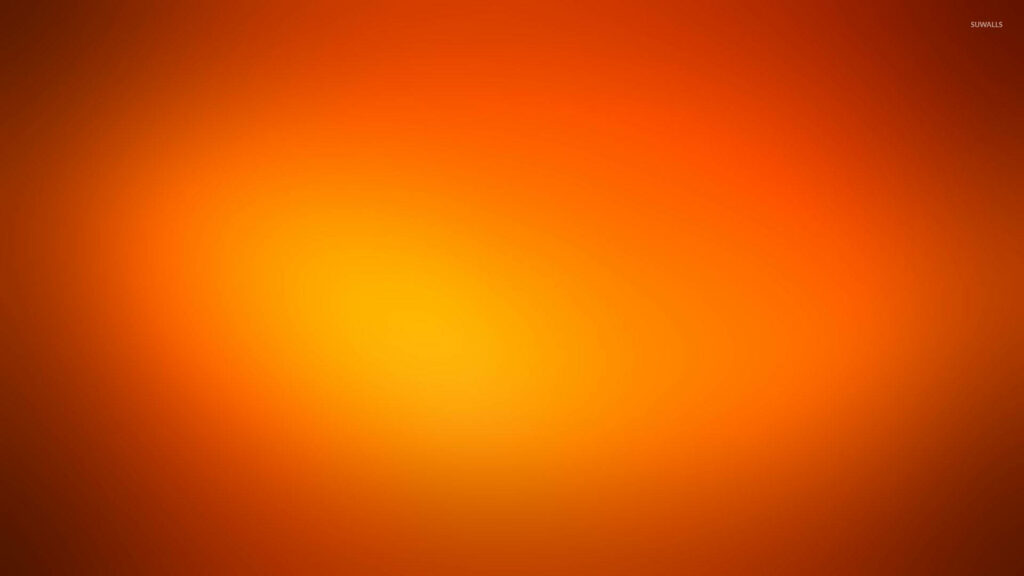 Vibrant glowing gradient wallpaper with yellow center fading to fiery orange and warm red tones