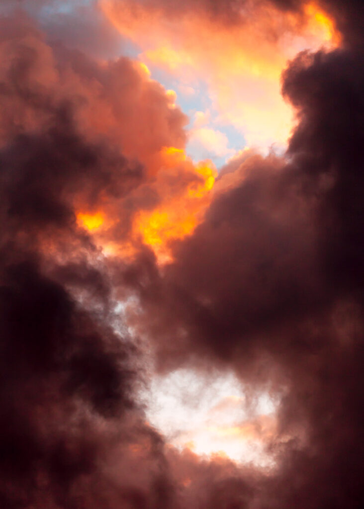 Dramatic sunset sky with fiery clouds in deep orange red and subtle blue vibrant nature wallpaper