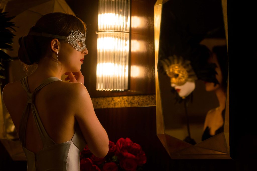 Dakota Johnson as Anastasia Steele in Fifty Shades Darker ornate silver mask gazing mirror Wallpaper