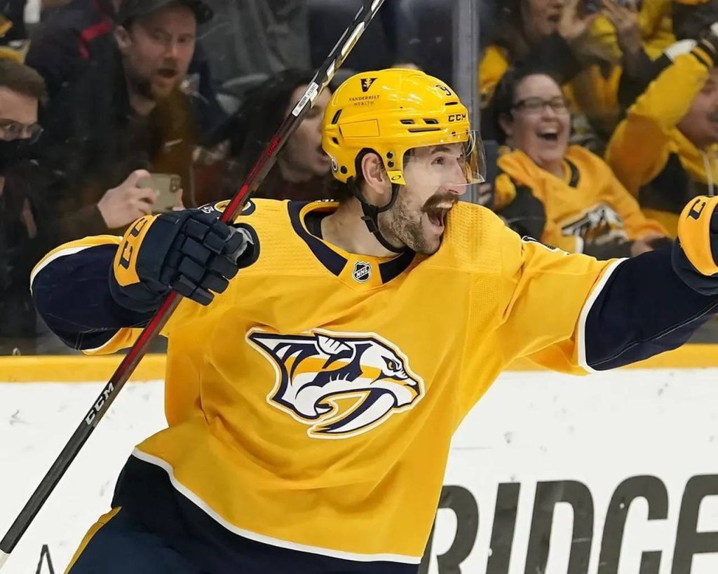 Filip Forsberg celebrating a goal in Nashville Predators yellow navy uniform NHL action wallpaper