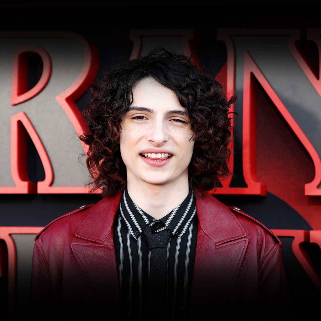 Finn Wolfhard Stranger Things wallpaper red jacket striped shirt iconic logo high-quality portrait